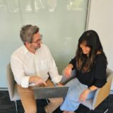 Rob Sheppard and Simmone Sache reviewing photos and approving for use